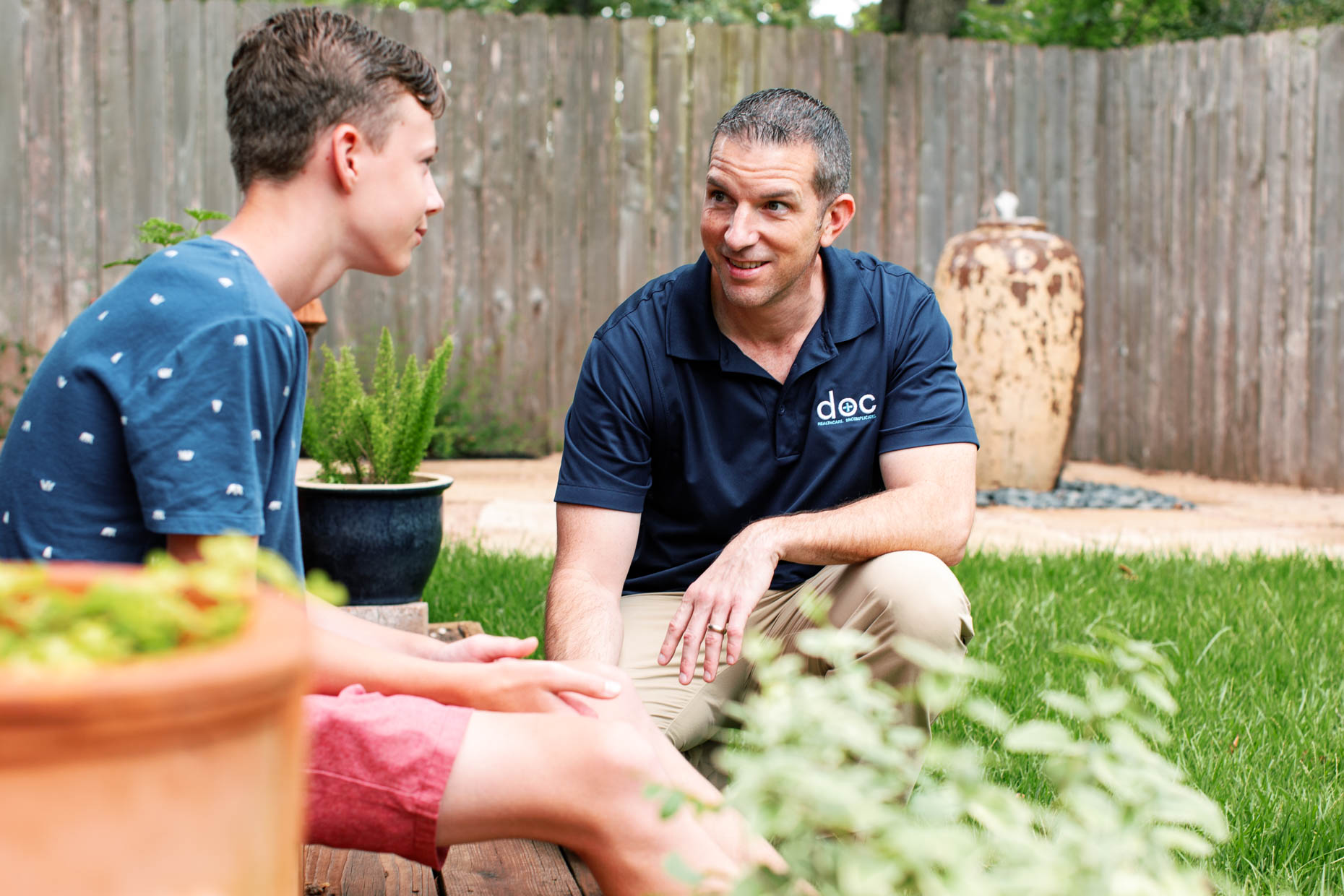 at home healthcare provider interacting with teenager outdoors