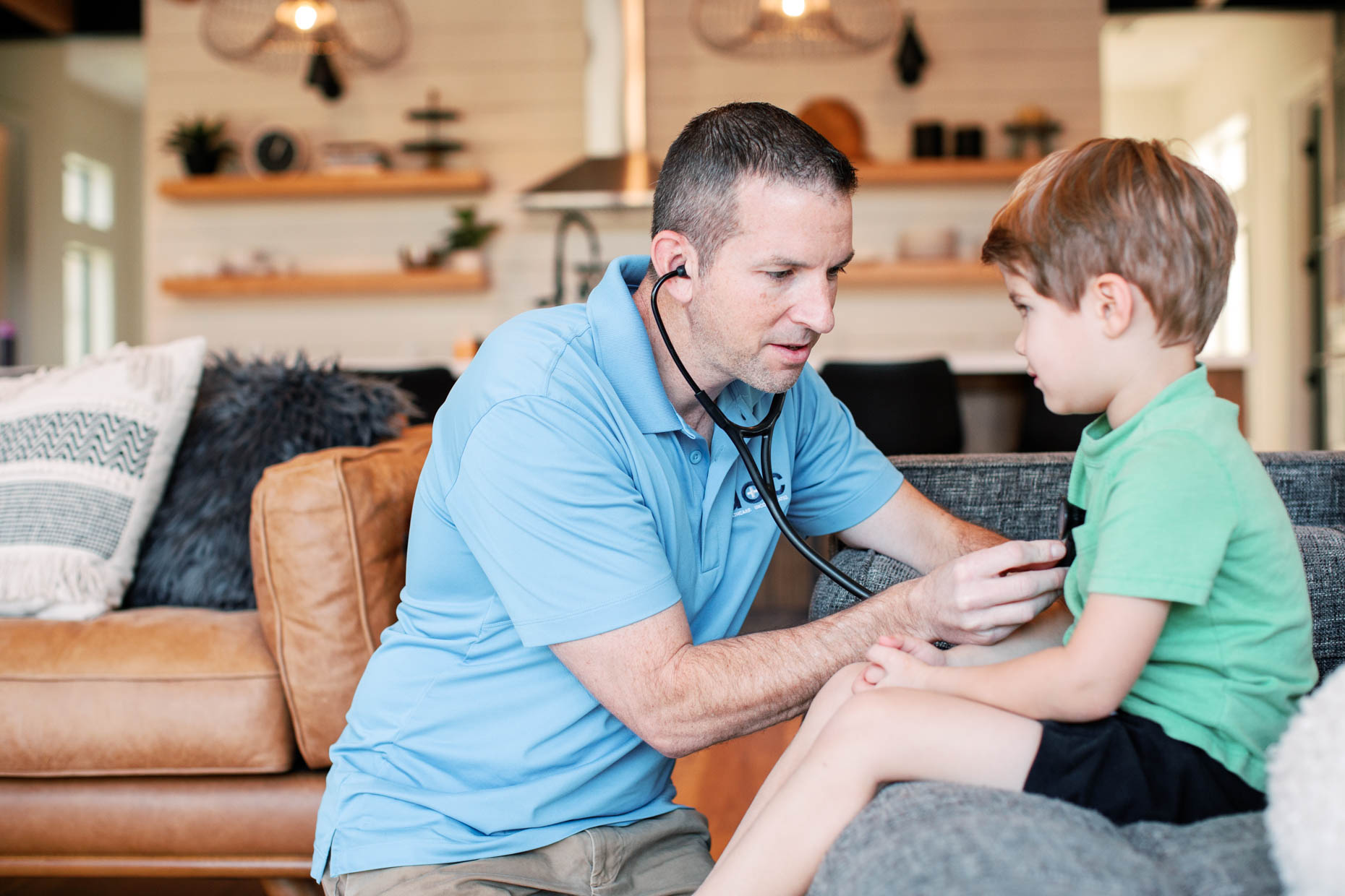 at home healthcare provider examining a little boy in home setting