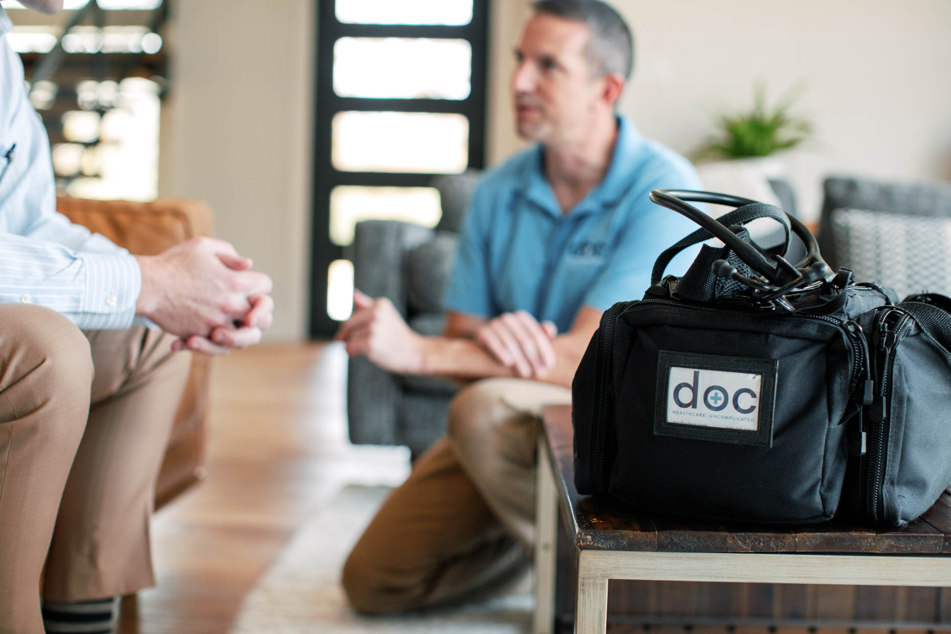 at home healthcare provider interacting with adult male