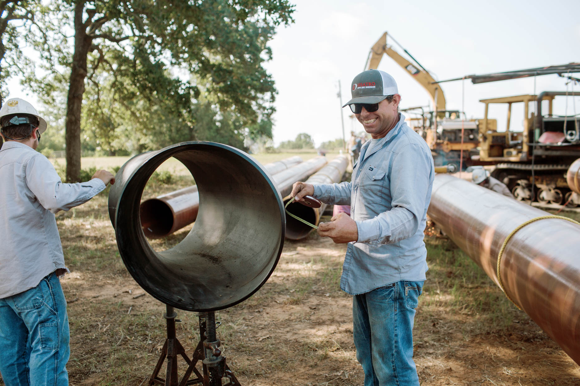 men working on pipes commercial photography for oil and gas pipeline company