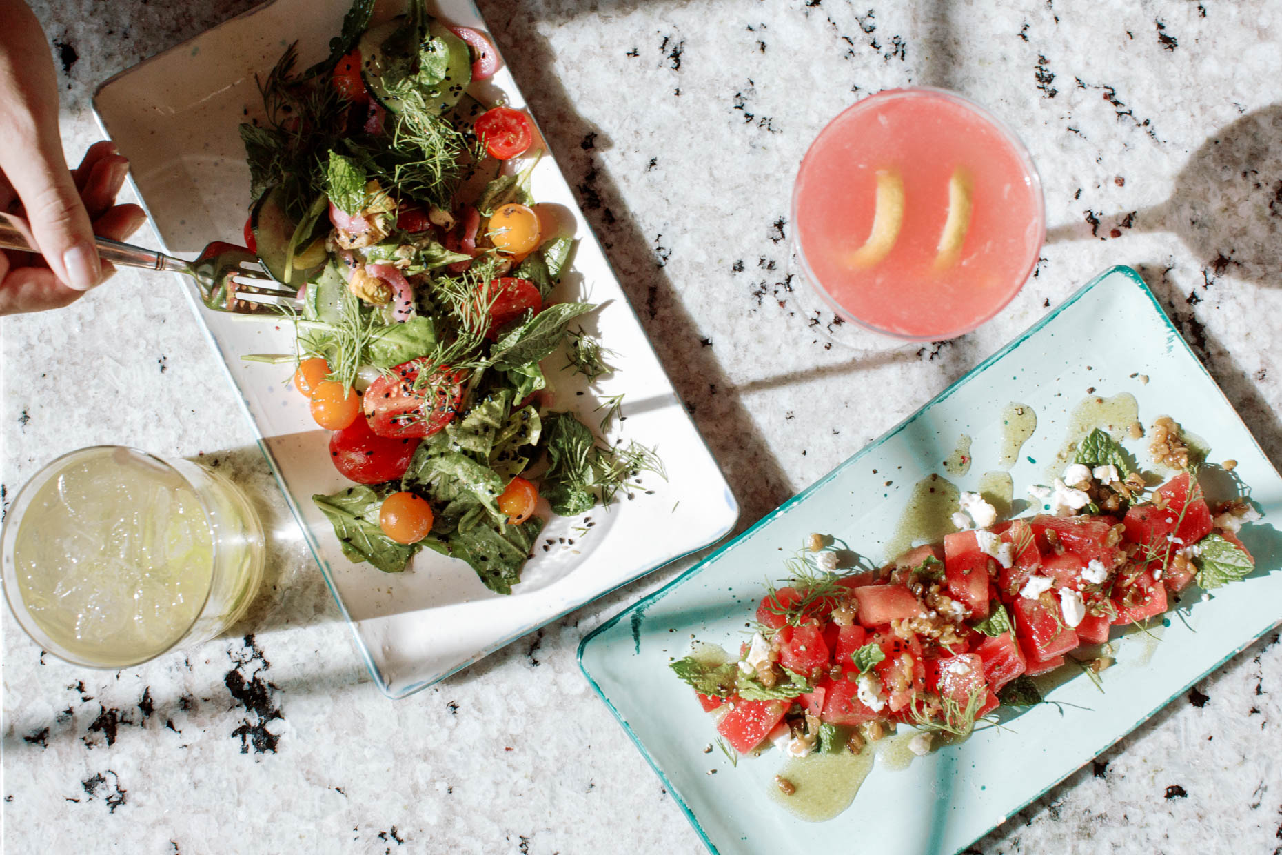 hard natural light food photography with summer vibes watermelon salad and cocktail