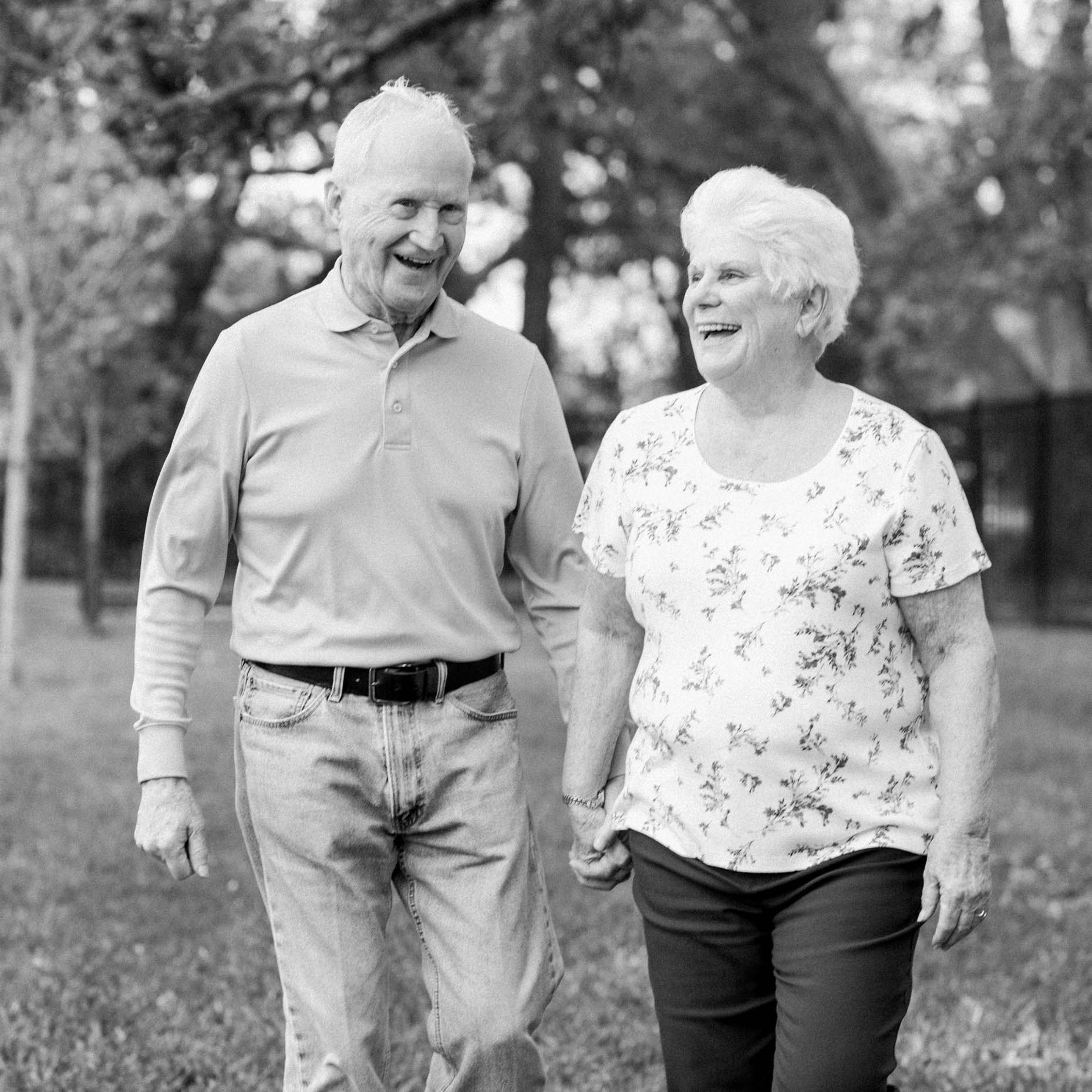 retired couple walking together outdoors at a senior living community
