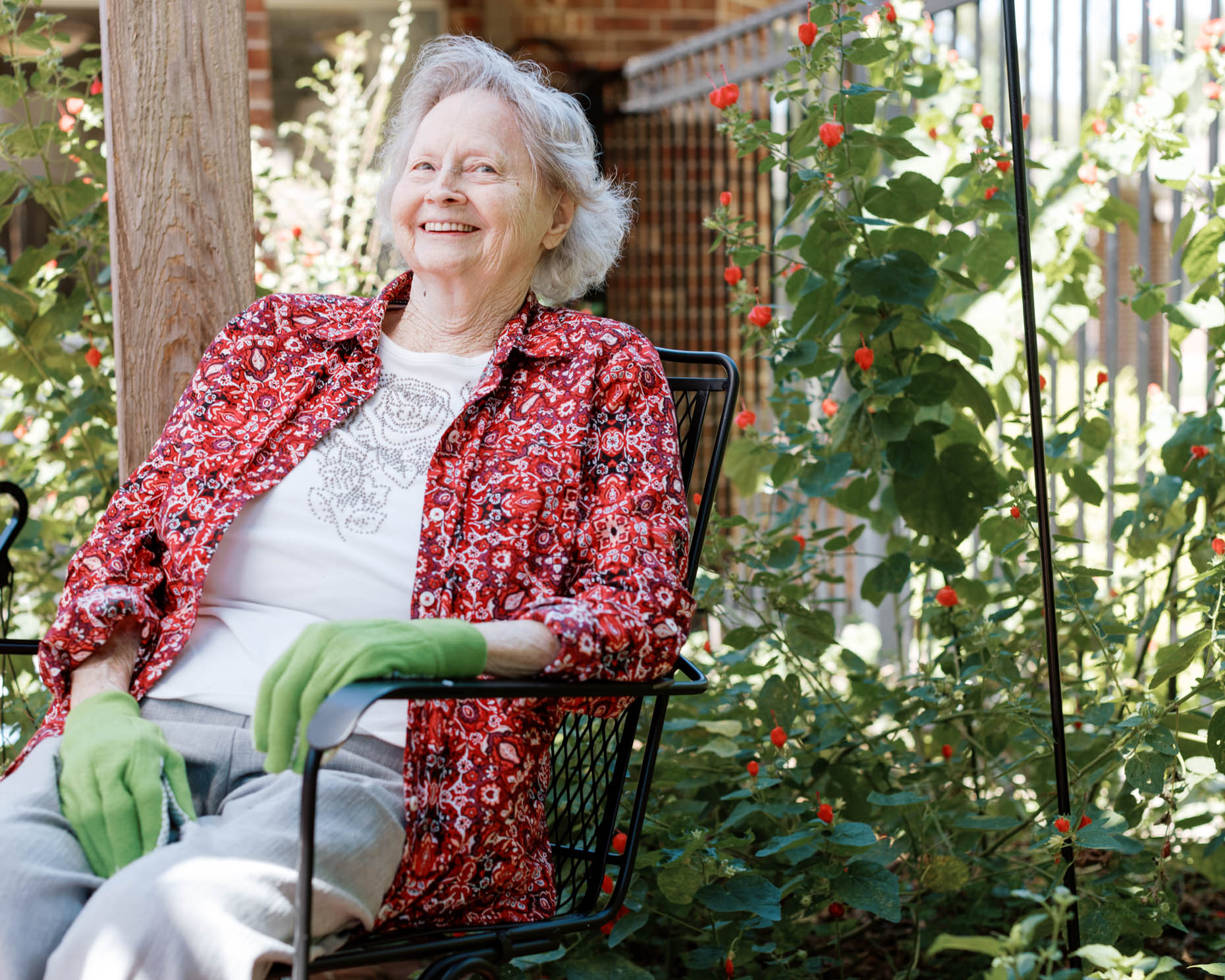 Retired woman sitting in garden at a senior living community