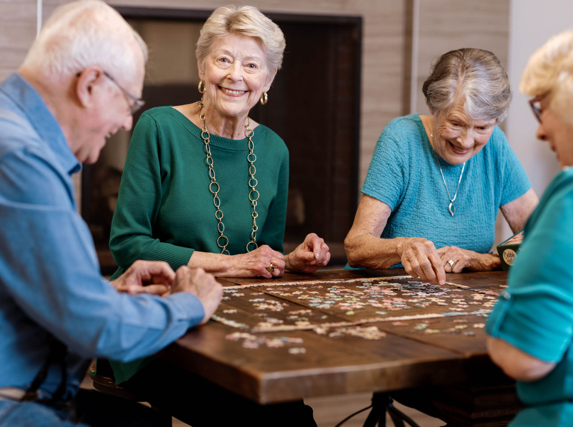 Retired people doing a puzzle together at a senior living community