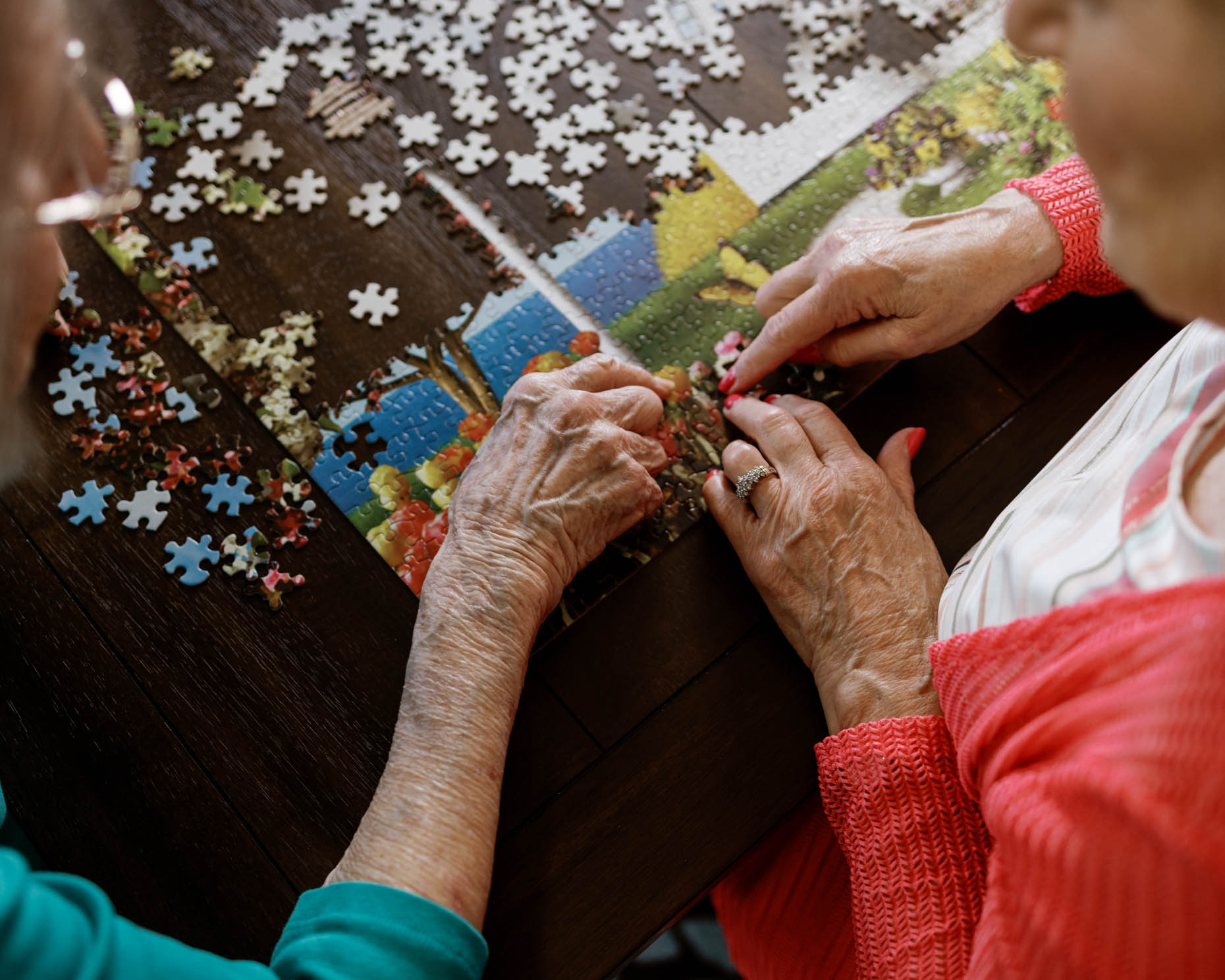 Elderly hands doing a puzzle at a senior living community