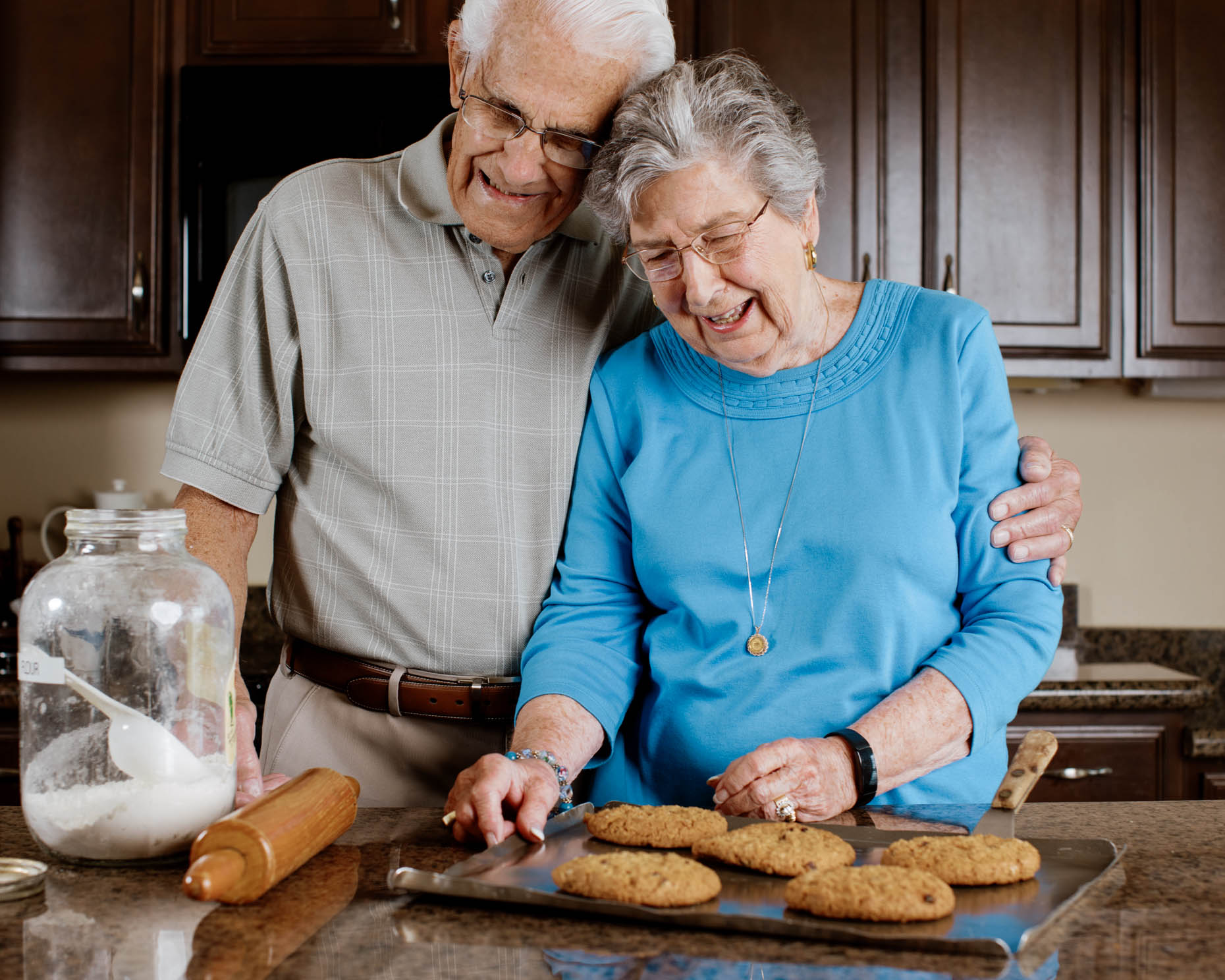 Retired couple cooking together in apartment at a senior living community