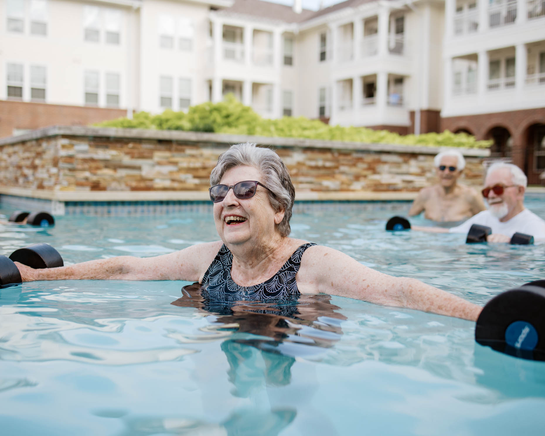 Retired people doing water aerobics at a senior living community