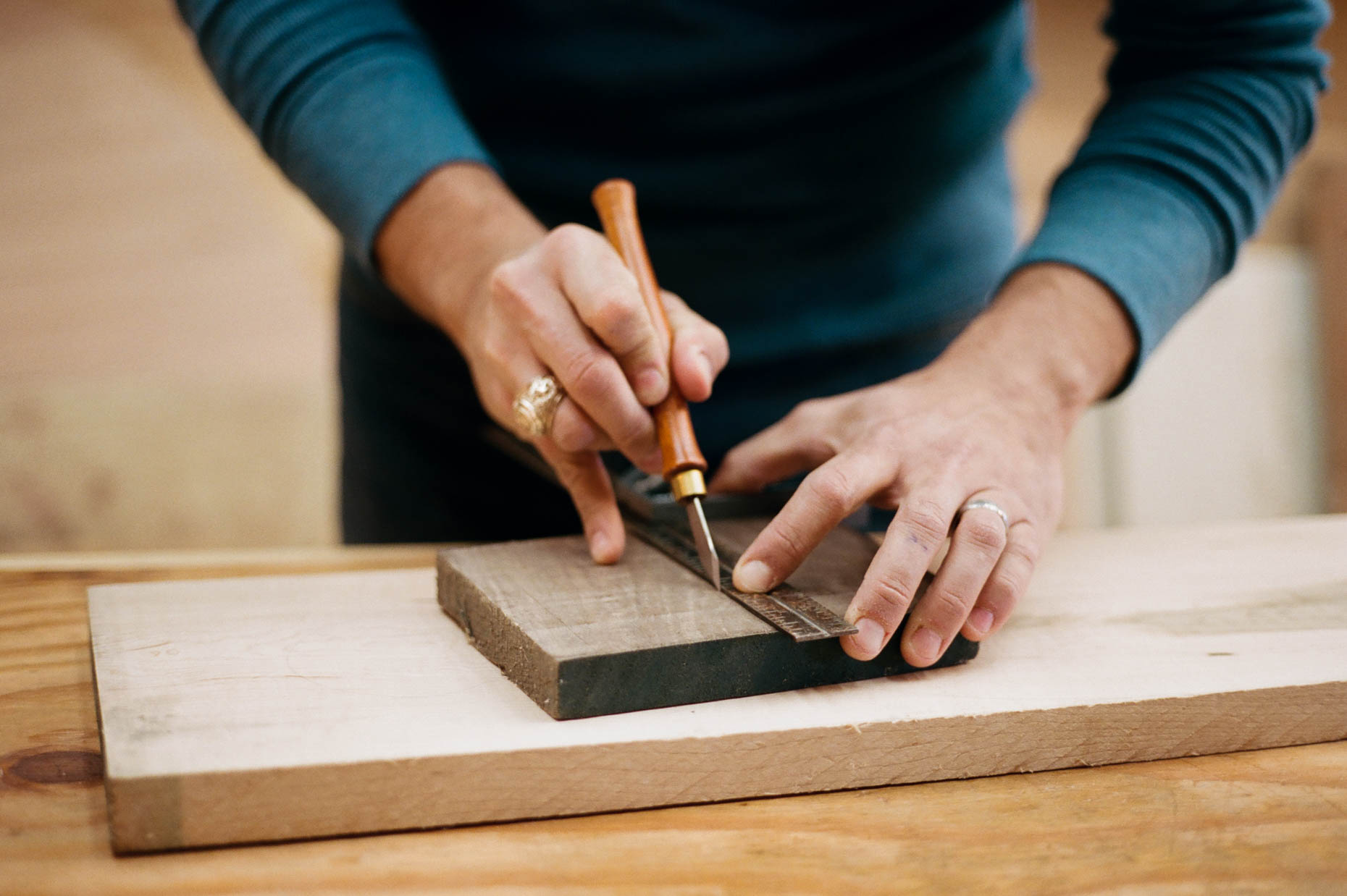 Woodworker hands marking a board