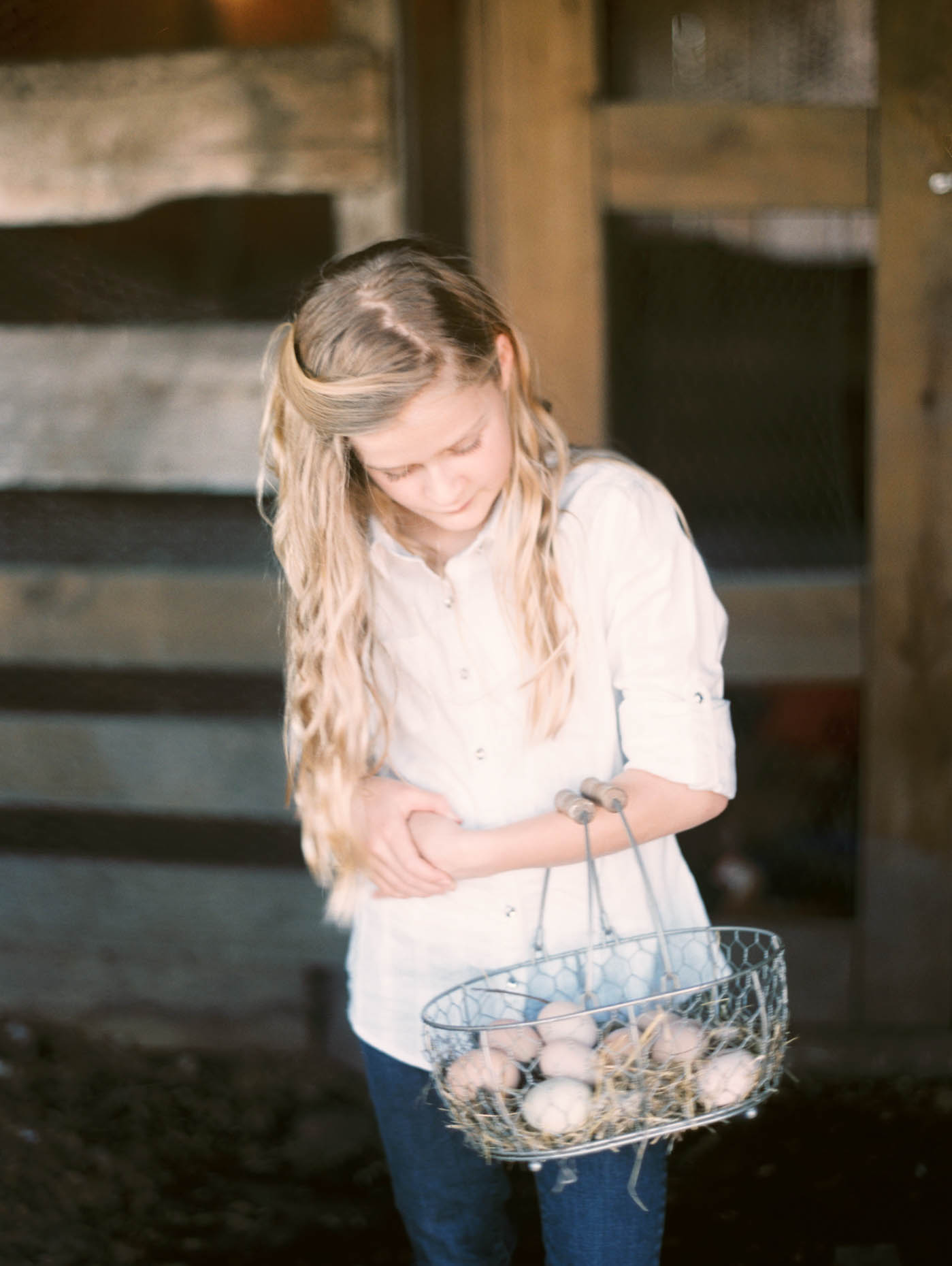 branding photos for a family owned Texas farm girl collecting eggs